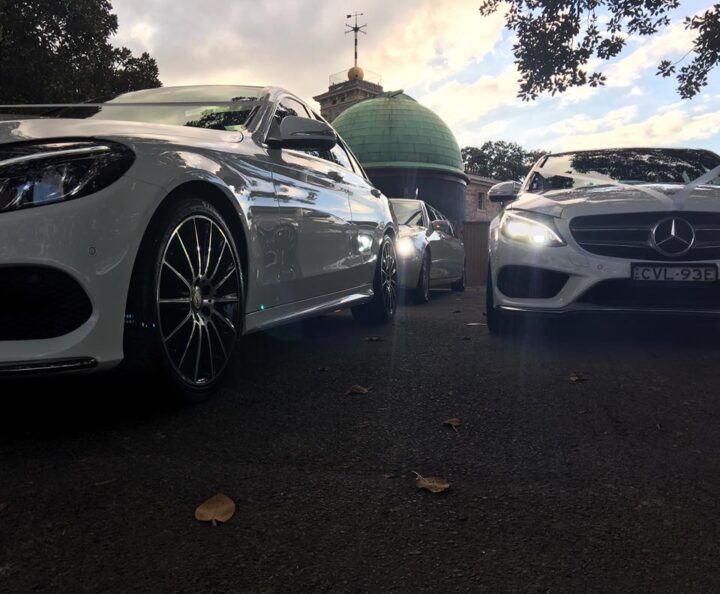 Multiple chauffeured vehicles lined up for a wedding