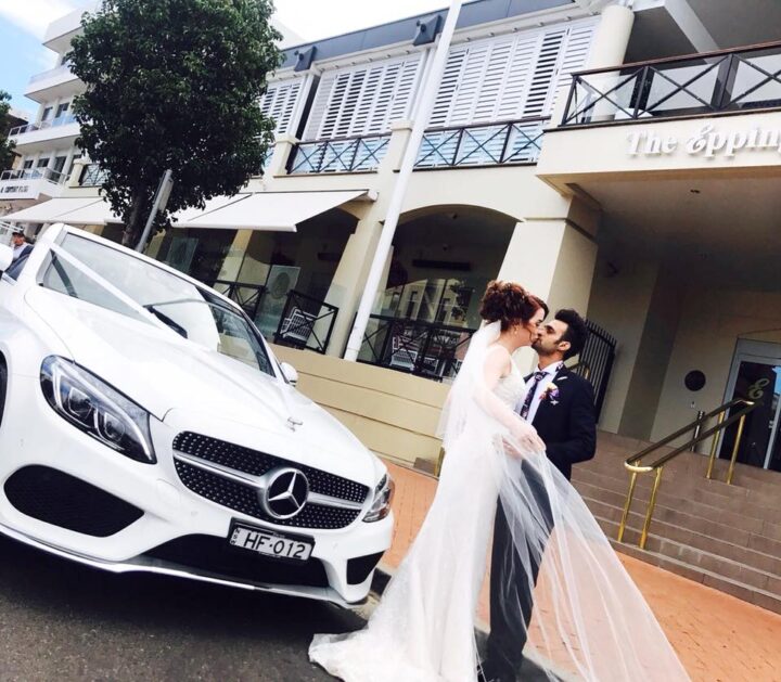 Wedding photographer capturing a luxury bridal car arrival