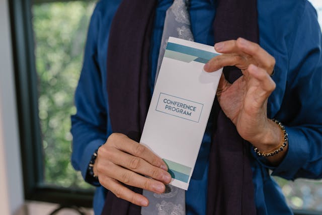 A Person Holding a Program Pamphlet.
