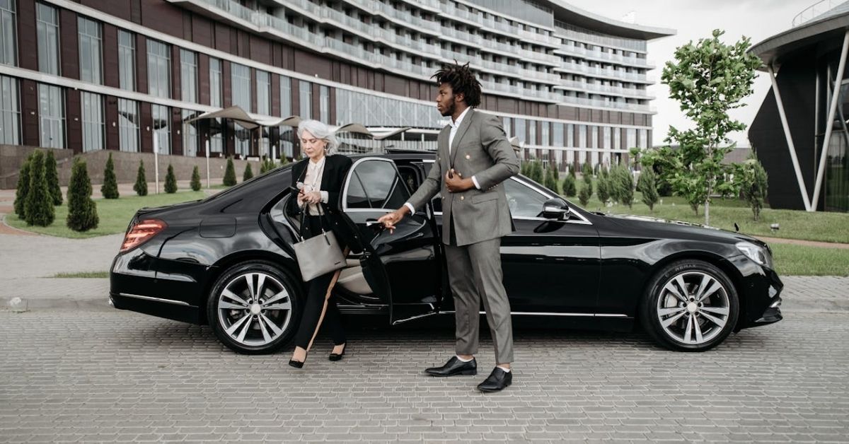 Woman in Black Blazer Standing beside Black Car