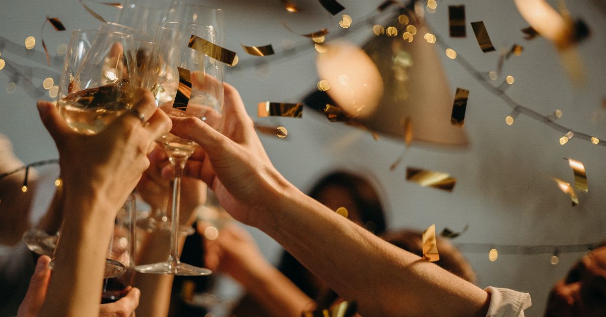 People toasting wine glasses on a party.