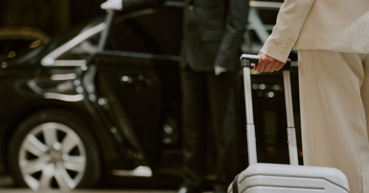 Executive traveller entering a luxury airport vehicle