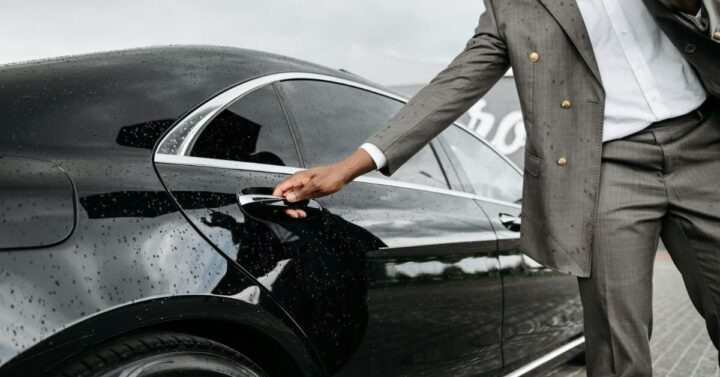 Man opening a car door for a VIP client.