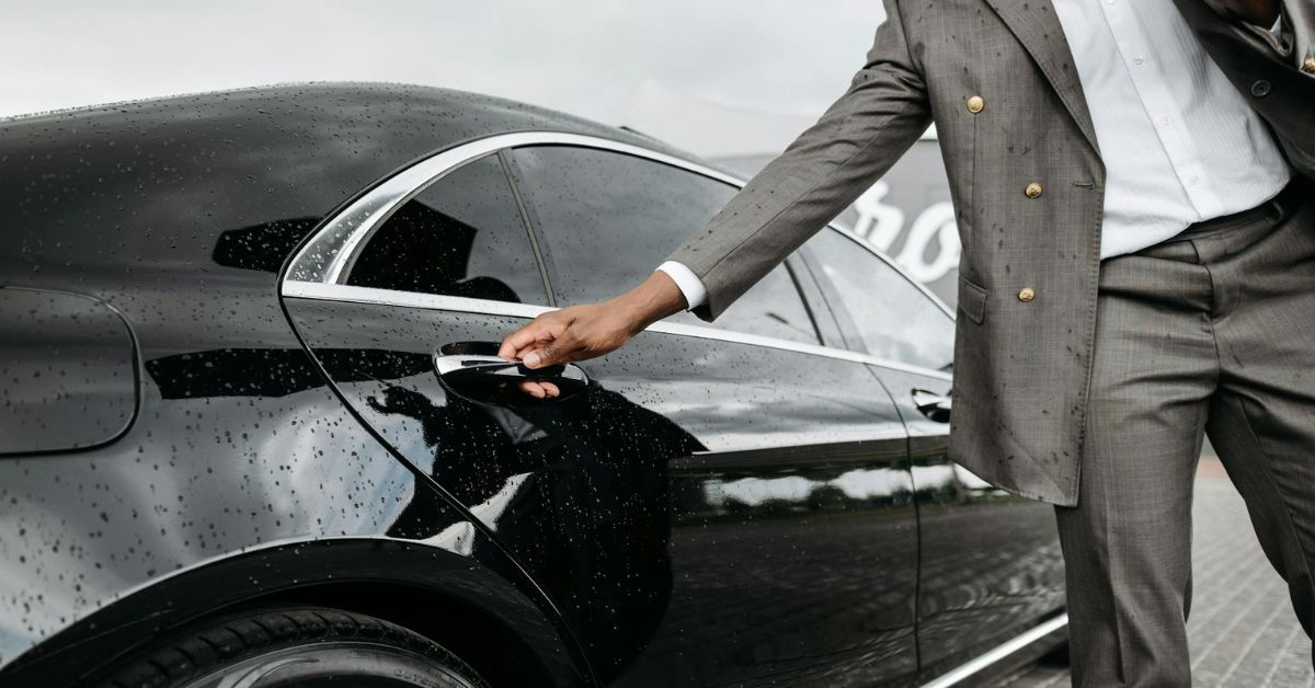 Man opening a car door for a VIP client.
