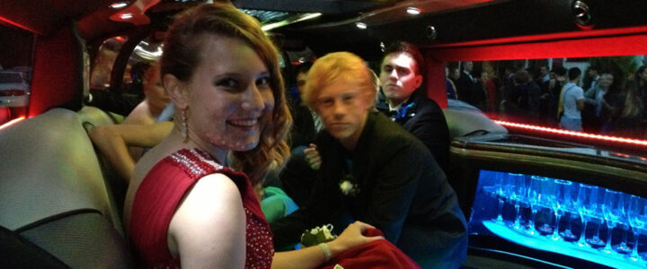 Students boarded in a coordinated group formal transport before a school formal