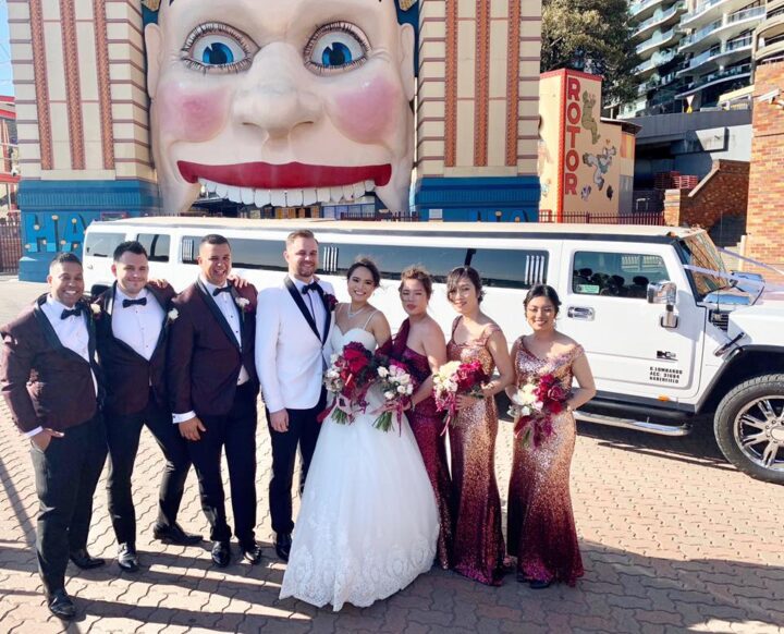 Congratulations to our couple Cameron and Rachel on their wedding day. Wedding party standing in front of our stretch Hummer limo at Luna Park entrance.