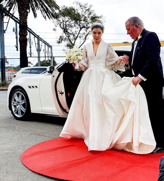 Luxury chauffeur vehicle arriving at a wedding venue
