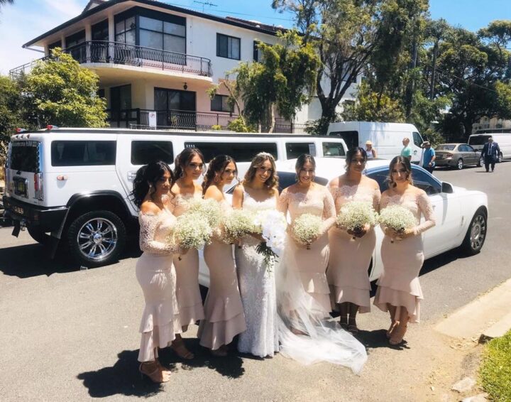 Bridal party preparing to board a luxury wedding vehicle